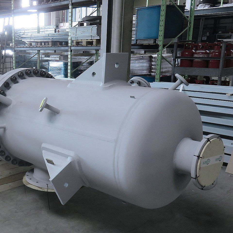 Long white industrial vessel in a warehouse