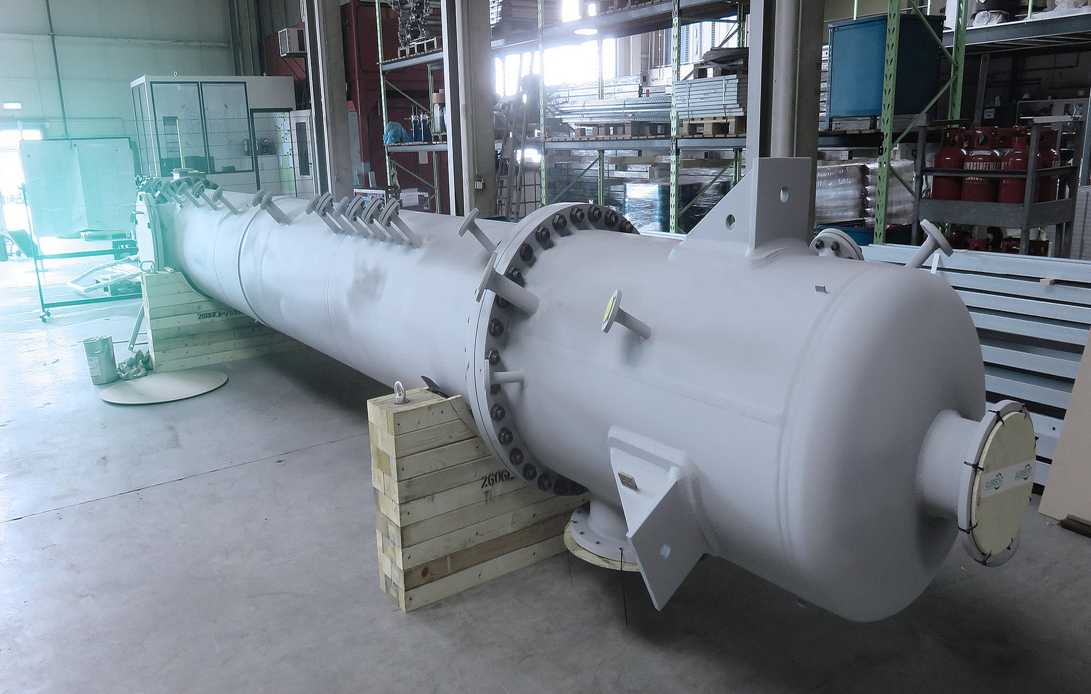 Long white industrial vessel in a warehouse